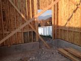 Looking from inside of single car garage out of garage back door