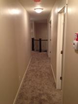 Carpet in upstairs hallway to banister