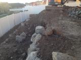 Lower rock wall and building pit