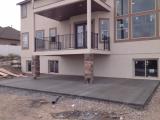 Great concrete pad under deck showing drain hose to landscape